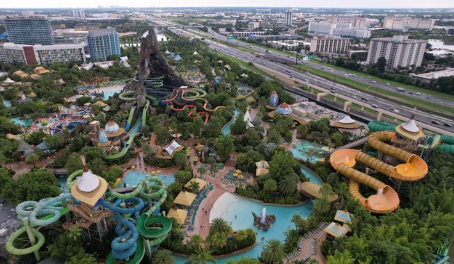 Hotels and highways are seen around Universal Volcano Bay water park, Friday, Aug. 22, 2025, in Orlando, Fla., which saw an influx of migrants in recent years drawn by warm temperatures, a vibrant migrant community, and plentiful job opportunities. (AP Photo/Rebecca Blackwell)