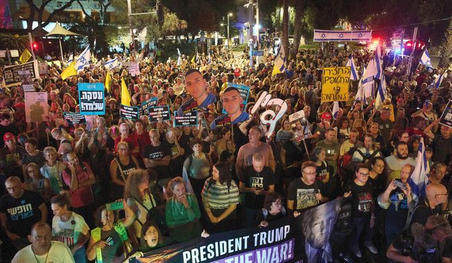 Demonstrators march in Tel Aviv, Israel, on Tuesday, Sept. 30, 2025, calling for the immediate release of all hostages held by Hamas in the Gaza Strip and an end to the ongoing war. (AP Photo/Ariel Schalit)