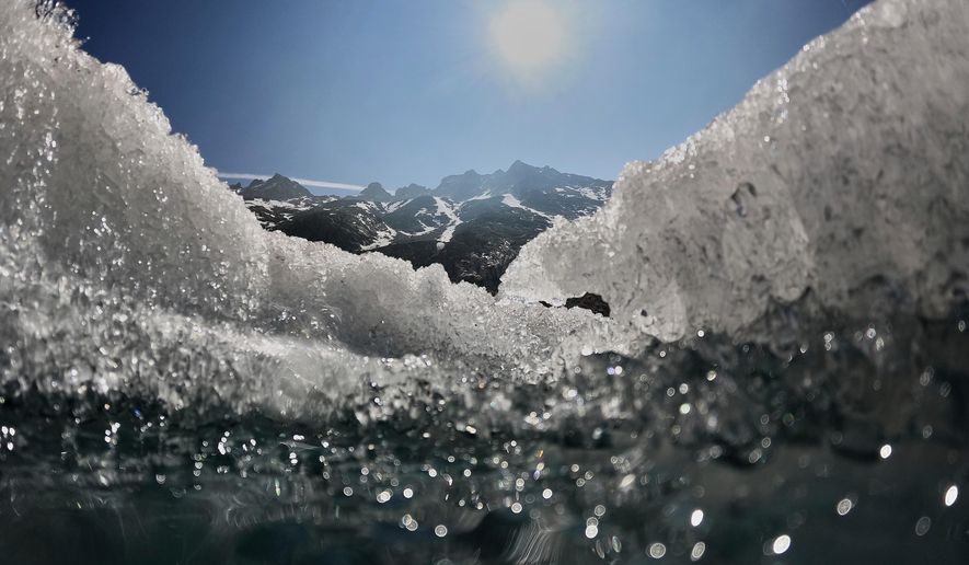 FILE - The sun shines over the melting Rhone Glacier near Goms, Switzerland, on June 10, 2025. (AP Photo/Matthias Schrader, File)