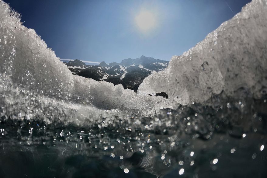 FILE - The sun shines over the melting Rhone Glacier near Goms, Switzerland, on June 10, 2025. (AP Photo/Matthias Schrader, File)