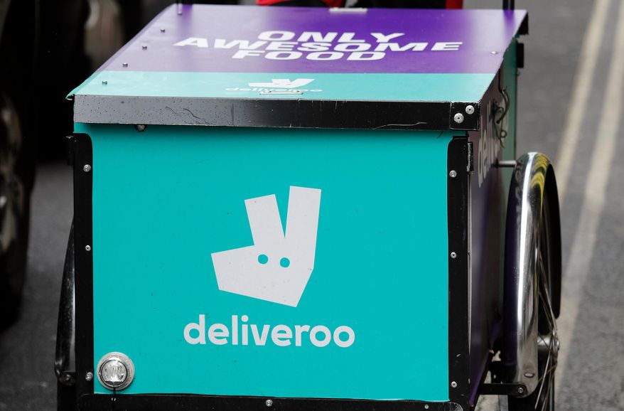 FILE - This July 11, 2017 file photo, shows a deliveroo logo on a bicycle in London. (AP Photo/Frank Augstein, File)