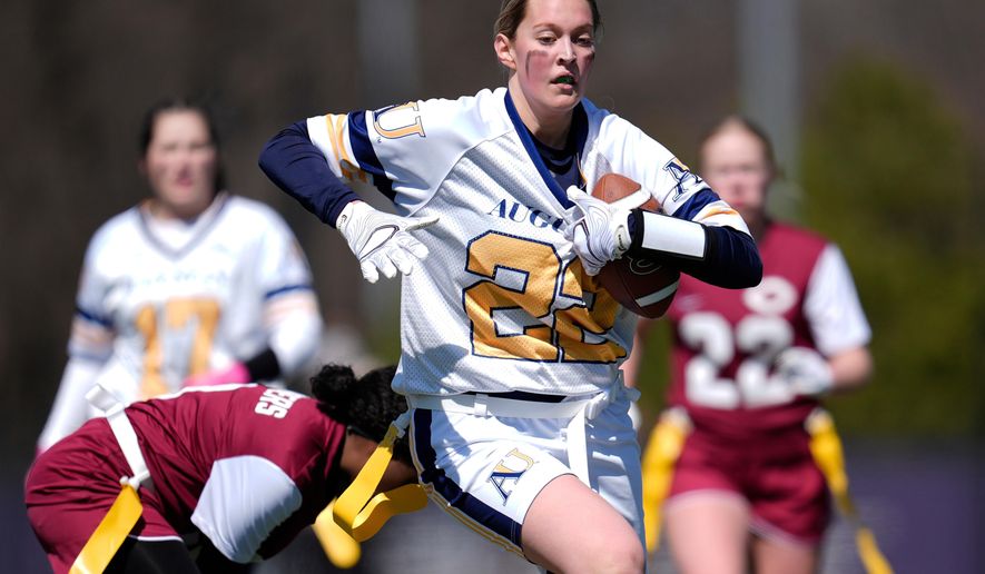 FILE - Augustana University and Concordia University, St. Paul players compete during a women's college flag football game, April 7, 2025, in St. Paul. Minn. (AP Photo/Abbie Parr, File)