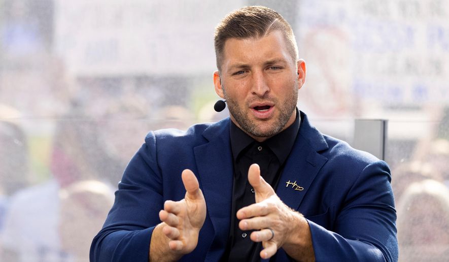 Tim Tebow talks to his co-hosts during the SEC Nation broadcast in Lexington, Ky., Oct. 9, 2021. (AP Photo/Michael Clubb, File)