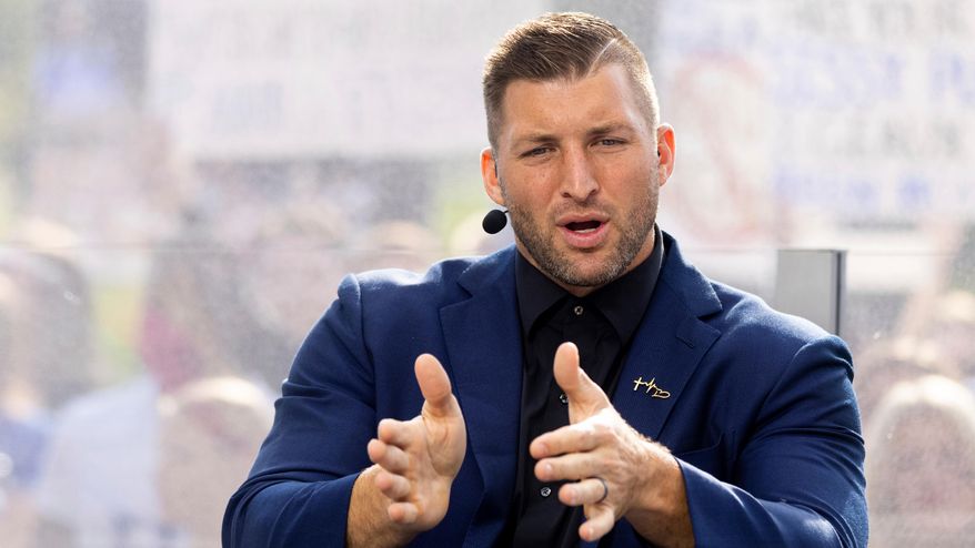 Tim Tebow talks to his co-hosts during the SEC Nation broadcast in Lexington, Ky., Oct. 9, 2021. (AP Photo/Michael Clubb, File)