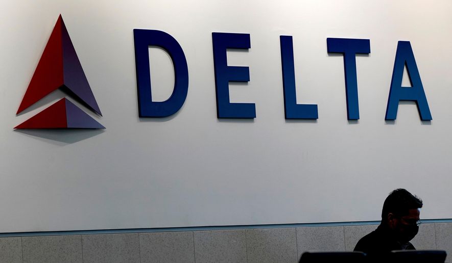 A man waits for a Delta Airlines flight at Hartsfield-Jackson International Airport in Atlanta on Jan. 7, 2022. (AP Photo/Charlie Riedel, File)