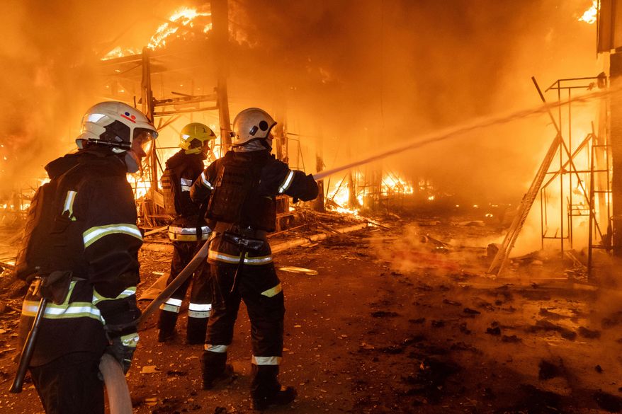 Firefighters tackle the blaze after a Russian air attack that hit at Barabashovo market in Kharkiv, Ukraine, Wednesday, Oct. 1, 2025. (AP Photo/Andrii Marienko)
