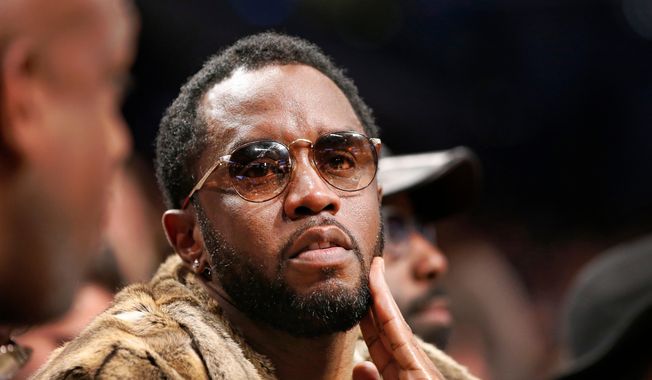 Sean "Diddy" Combs sits courtside in the second half of an NBA basketball game between the Brooklyn Nets and the New York Knicks, March 12, 2017, in New York. (AP Photo/Kathy Willens, File)