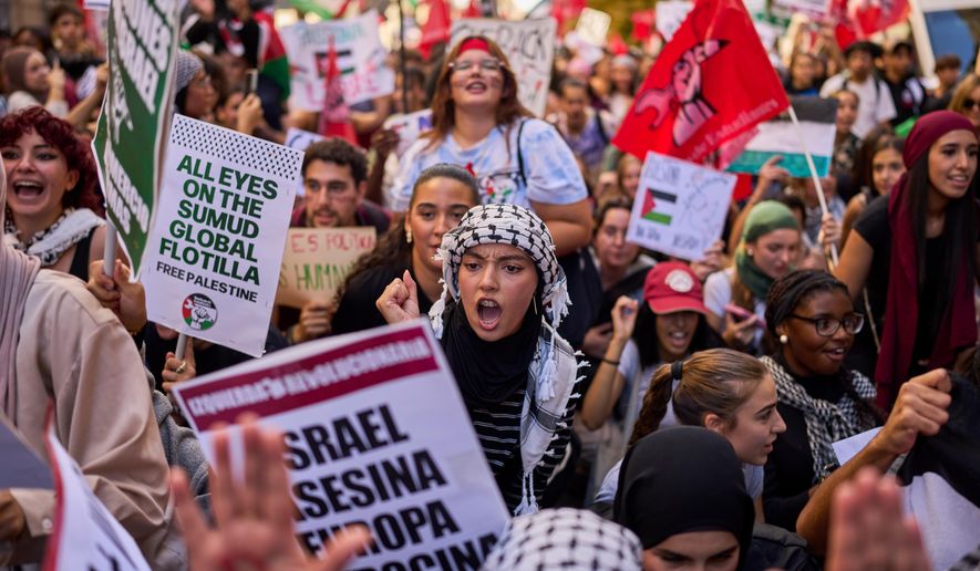 Students protest during a pro-Palestinian demonstration in Madrid, Spain, Thursday, Oct. 2, 2025, in solidarity with the Global Sumud Flotilla after ships were intercepted by the Israeli navy. (AP Photo/Manu Fernandez)
