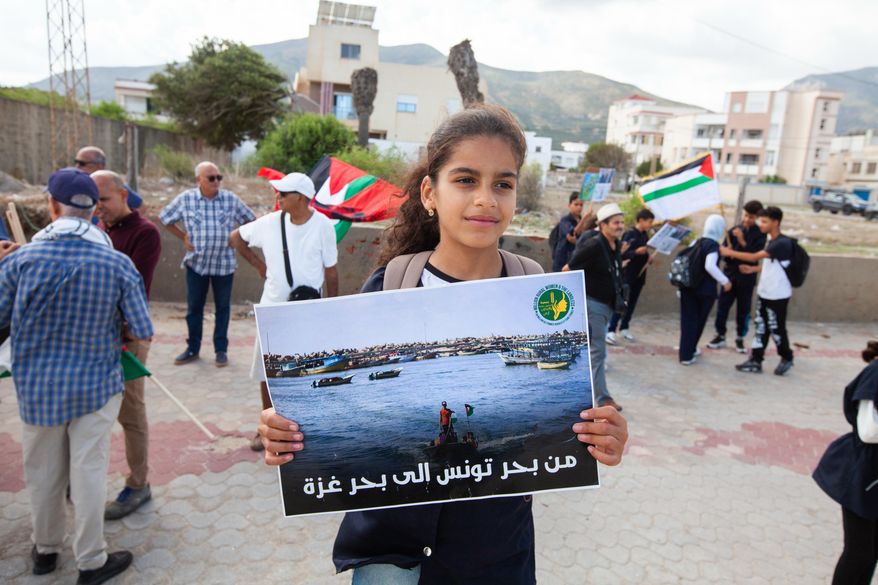 Demonstrators gather at a memorial site honoring the victims of the 1985 Israeli attack on Palestine Liberation Organization's headquarters, in Hammam Chott outside Tunisia's capital, Wednesday, Oct. 1, 2025. Banner in Arabic reads "From the sea of Tunisia to the sea of Gaza". (AP Photo/Ons Abid)