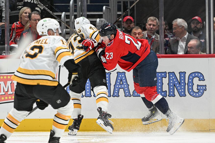 Washington Capitals forward Sheldon Rempal (23) putting a hit on Boston Bruins defenseman Jordan Harris (43) during the second period of a preseason NHL game at Capital One Arena in Washington D.C., October 2, 2025. (Photo for the Washington Times)
