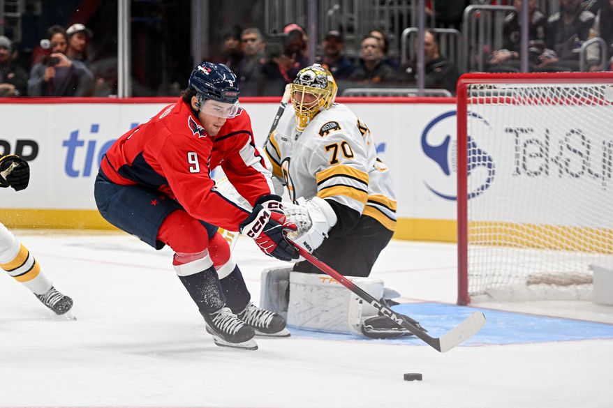Washington Capitals forward Ryan Leonard (9) reaching for the puck in front of the net during the second period of a preseason NHL game against the Boston Bruins at Capital One Arena in Washington D.C., October 2, 2025. (Photo for the Washington Times)