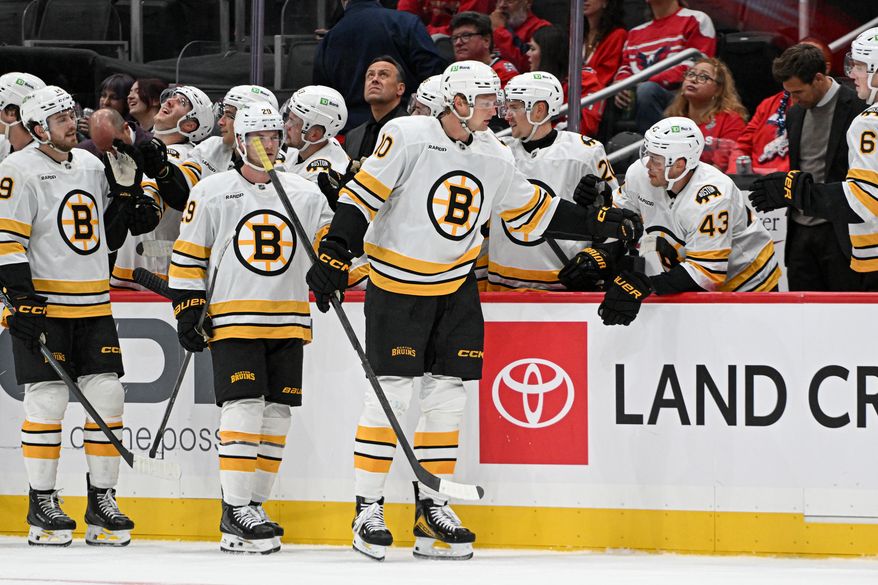 Boston Bruins forward Riley Tufte (10) getting congratulated by teammates after scoring during the second period of a preseason NHL game against the Washington Capitals at Capital One Arena in Washington D.C., October 2, 2025. (Photo for the Washington Times)