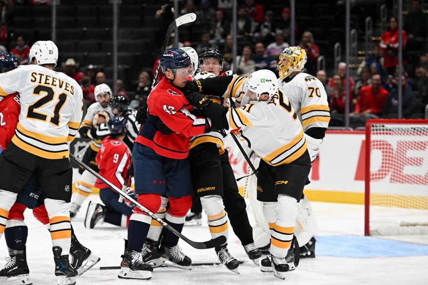 Washington Capitals defenseman Martin Fehervary (42) getting into a scuffle with Boston Bruins forward Matt Poitras (51) during the third period of a preseason NHL game at Capital One Arena in Washington D.C., October 2, 2025. (Photo for the Washington Times)
