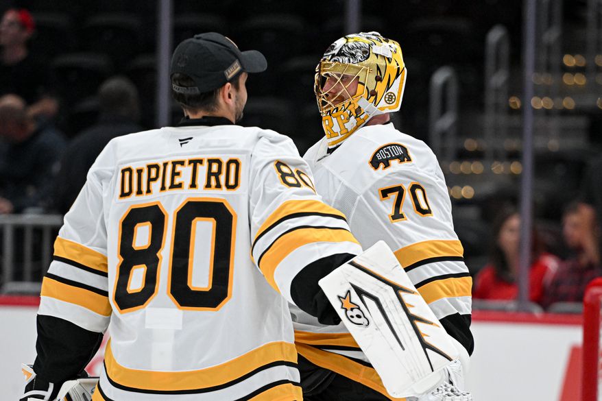 Boston Bruins goalie Joonas Korpisalo (70) getting congratulated by teammate Michael DiPietro (80) after the team's 2-1 win over the Washington Capitals in a preseason NHL game at Capital One Arena in Washington D.C., October 2, 2025. (Photo for the Washington Times)