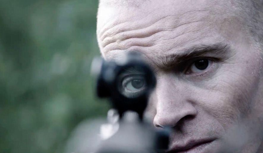 FILE - In this photo provided by Neon, former U.S. Green Beret Jordan Goudreau holds an assault rifle as part of a documentary film on the combat veteran's involvement in a coup attempts against Venezuelan President Nicolas Maduro. (Neon via AP, File)