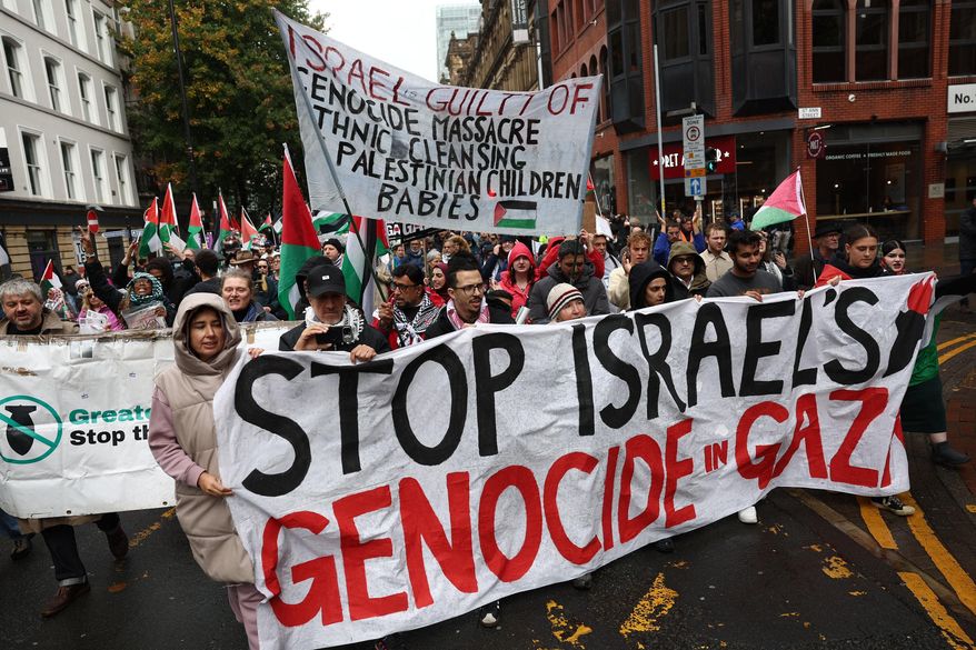 People take part in a demonstration organized by GM Friends of Palestine at Manchester Cathedral, in Manchester, England, Saturday, Oct. 4 2025. (Ryan Jenkinson/PA via AP)