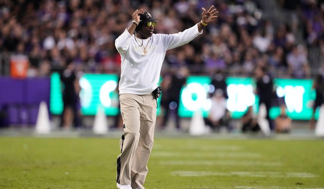 Colorado head coach Deion Sanders calls for a time out in the first half of an NCAA college football game against TCU Saturday, Oct. 4, 2025, in Fort Worth, Texas. (AP Photo/Tony Gutierrez)