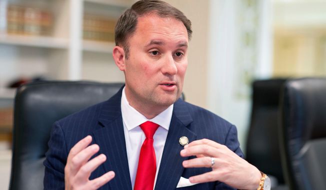 FILE - Virginia Attorney General Jason Miyares speaks during an interview at the Office of the Attorney General in Richmond, Va., May 9, 2023. (AP Photo/Ryan M. Kelly, File)