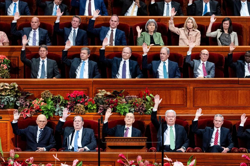 Elder Henry B. Eyring, bottom center, of the Quorum of the Twelve Apostles, and other Church leaders raise their hands as part of a sustaining vote during the morning session of the 195th Semiannual General Conference of The Church of Jesus Christ of Latter-day Saints at the Conference Center in Salt Lake City on Saturday, Oct. 4, 2025. (Isaac Hale/The Deseret News via AP)