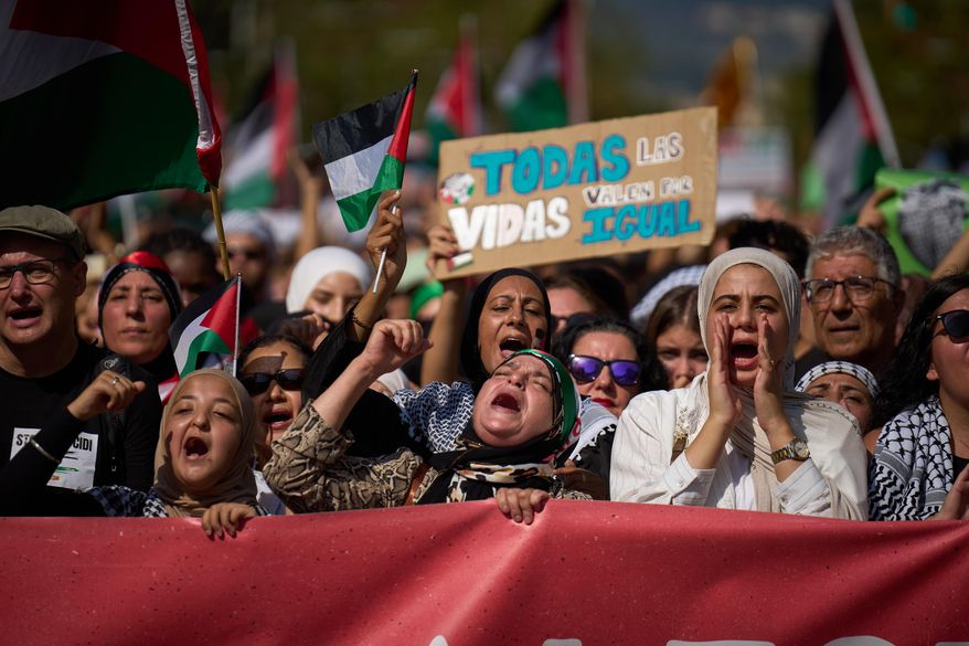 Demonstrators shout slogans as they march during a pro-Palestinian rally in solidarity with the Global Sumud Flotilla after ships were intercepted by the Israeli navy, in Barcelona, Spain, Saturday, Oct. 4, 2025. (AP Photo/Emilio Morenatti)