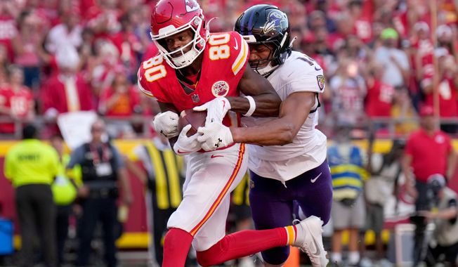 Kansas City Chiefs wide receiver Tyquan Thornton (80) catches a touchdown pass as Baltimore Ravens safety Kyle Hamilton defends during the second half of an NFL football game Sunday, Sept. 28, 2025, in Kansas City, Mo. (AP Photo/Charlie Riedel)