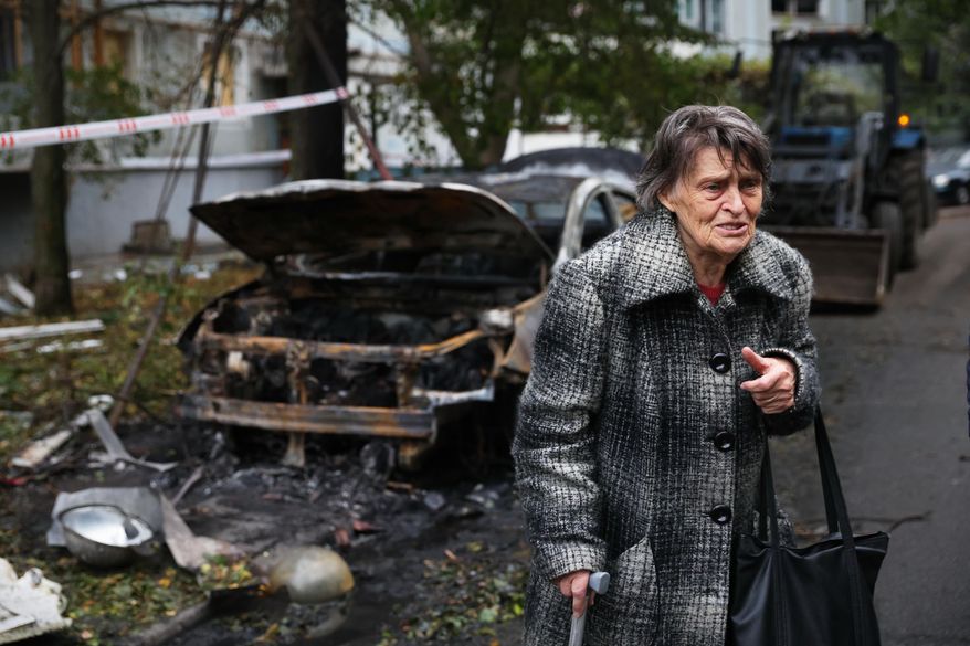 An elderly woman reacts next to the house destroyed by a Russian strike in Zaporizhzhia, Ukraine, Sunday, Oct. 5, 2025. (AP Photo/Kateryna Klochko)