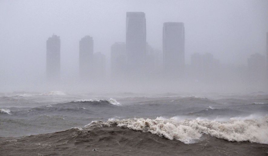 In this photo released by Xinhua News Agency, strong waves are seen ahead of Typhoon Matmo near the coastal downtown area of Haikou, in southern China's Hainan Province on Sunday, Oct. 5, 2025. (Guo Cheng/Xinhua via AP)