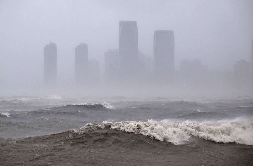 In this photo released by Xinhua News Agency, strong waves are seen ahead of Typhoon Matmo near the coastal downtown area of Haikou, in southern China's Hainan Province on Sunday, Oct. 5, 2025. (Guo Cheng/Xinhua via AP)
