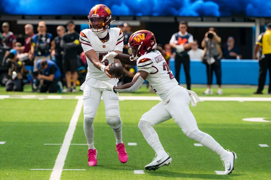 Washington Commanders Quarterback Jayden Daniels (5) hands off ball to Running Back Jacory Crosket-Merritt (22) at SoFi Stadium in Inglewood California. The Washington Commanders defeated the Los Angeles Chargers 27-10 during NFL Week 5 on October 5th, 2025. (Photo by Jordan Sabillo for Washington Times)
