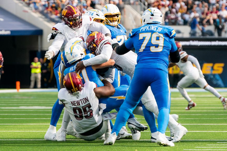 Washington Commanders Defensive Lineman Jer’Zhan Newton (95), Jacob Martin (55), and Javon Kinlaw (99) sack Los Angeles Quarterback Justin Herbert (10) at SoFi Stadium in Inglewood California. The Washington Commanders defeated the Los Angeles Chargers 27-10 during NFL Week 5 on October 5th, 2025. (Photo by Jordan Sabillo for Washington Times)