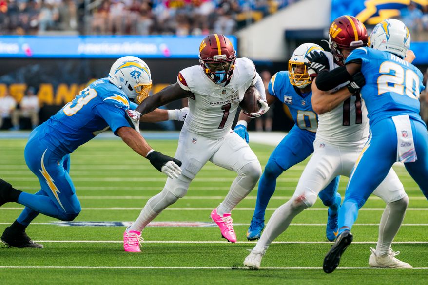 Washington Commanders Wide Receiver Deebo Samuel (1) stiff arms Los Angeles Chargers Linebacker Troy Dye(43) at SoFi Stadium in Inglewood California. The Washington Commanders defeated the Los Angeles Chargers 27-10 during NFL Week 5 on October 5th, 2025. (Photo by Jordan Sabillo for Washington Times)