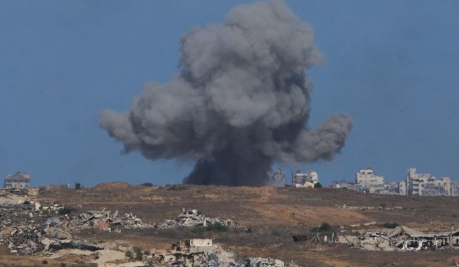 Smoke billows over Gaza Strip following an Israeli bombardment, as seen from southern Israel, Sunday, Oct. 5, 2025. (AP Photo/Ariel Schalit)
