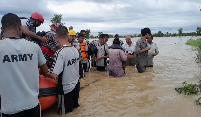 Nepalese army personnel transport survivors after a flood in Jhapa district east of Nepal, Sunday, Oct. 5, 2025. (Nepal Army via AP)