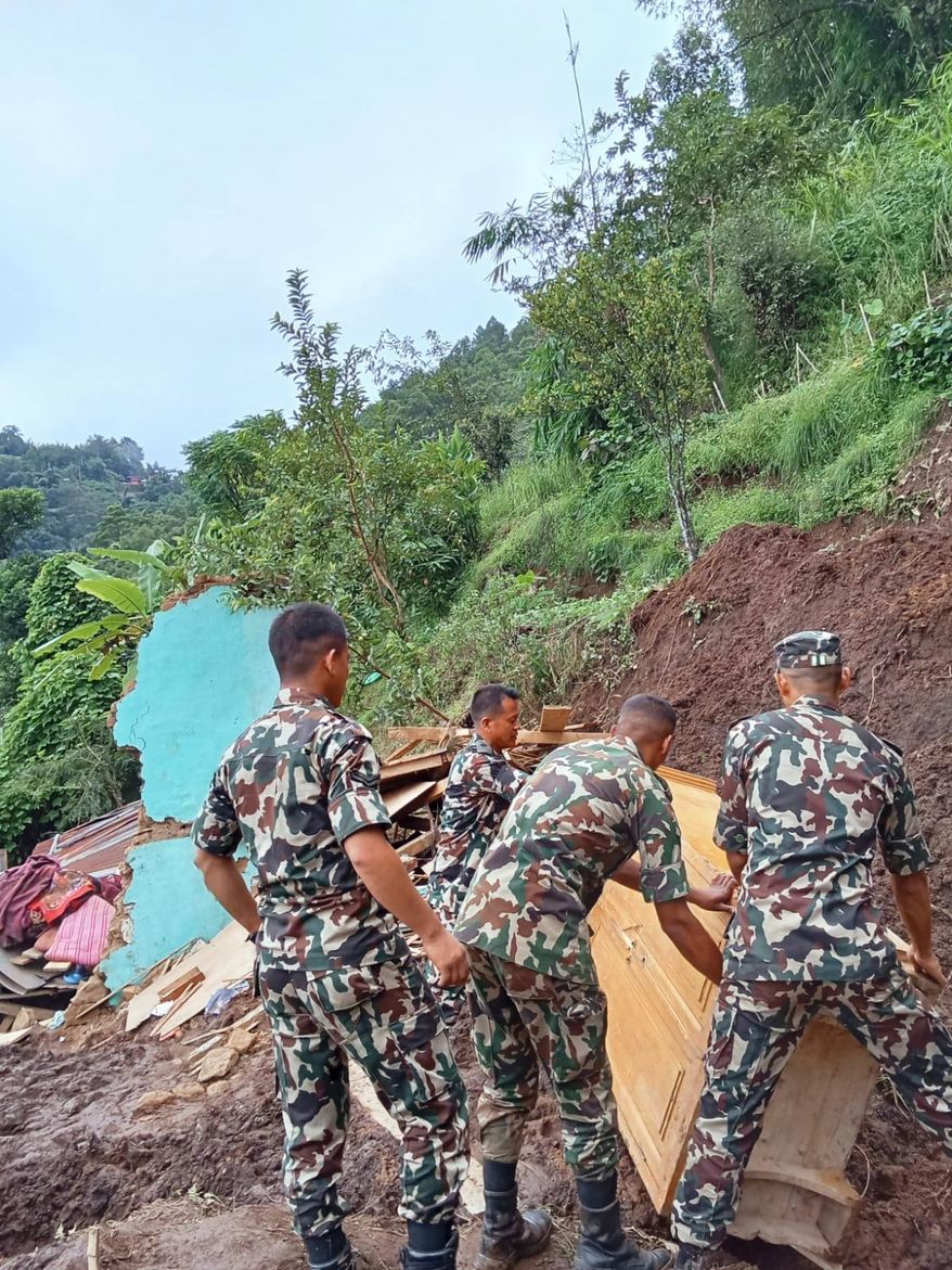 Nepalese army personnel search for survivors after landslides swept through Nepal's eastern mountain district of Illam, Nepal, Sunday, Oct. 5, 2025. (Nepal Army via AP)