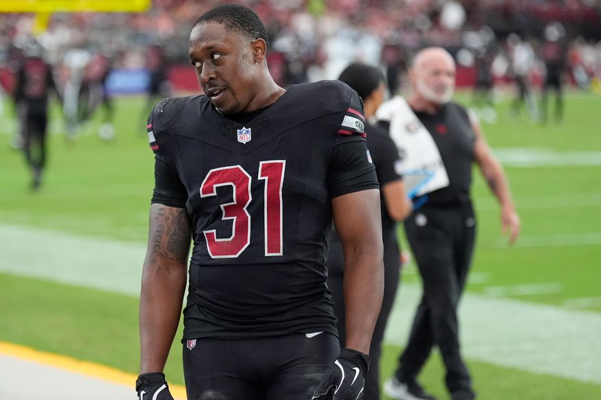 Arizona Cardinals running back Emari Demercado (31) reacts on the sideline after fumbling the ball out of the end zone on a touchdown run during the second half of an NFL football game against the Tennessee Titans, Sunday, Oct. 5, 2025, in Glendale, Ariz. (AP Photo/Ross D. Franklin)