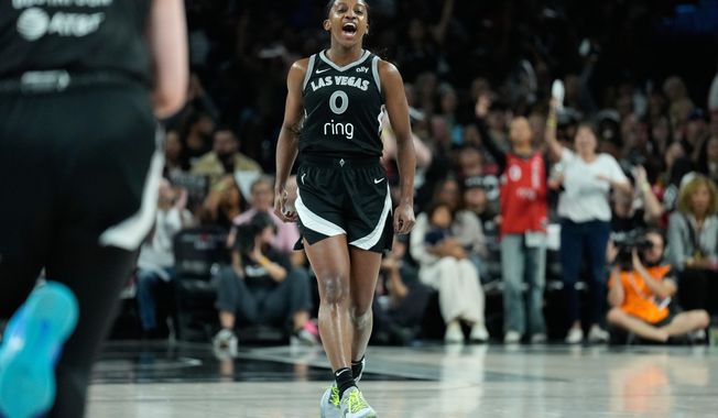 Las Vegas Aces guard Jackie Young (0) celebrates after making a 3-point shot during the second half in Game 2 of the WNBA basketball finals against the Phoenix Mercury, Sunday, Oct. 5, 2025, in Las Vegas. (AP Photo/John Locher)