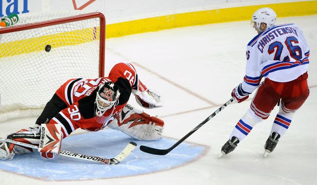 FILE - New York Rangers' Erik Christensen, right, scores a goal against New Jersey Devils goaltender Martin Brodeur during the shootout of an NHL hockey game March 25, 2010 in Newark, N.J. (AP Photo/Bill Kostroun, File)