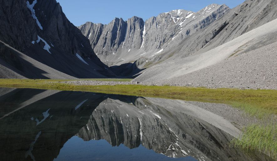 In this July 30, 2014 photo provided by the National Park Service is a small tarn in a hidden valley in the Itkillik Preserve at the Arctic National Park and Preserve in Alaska. The nation’s northernmost national park says its new management plan will have to consider the effects of a new industrial road to the mining district of Ambler, the first road that would be constructed within its Maryland-sized boundaries. (AP Photo/National Park Service, Cadence Cook)