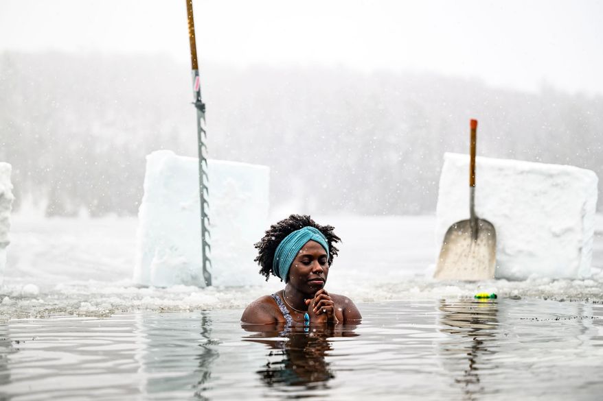 FILE - Canda-Leigh Habonimana dips in the waters of Gatineau Park's Meech Lake in Chelsea, Que., during a polar bear dip on New Year's Day, Jan. 1, 2025. (Justin Tang /The Canadian Press via AP)
