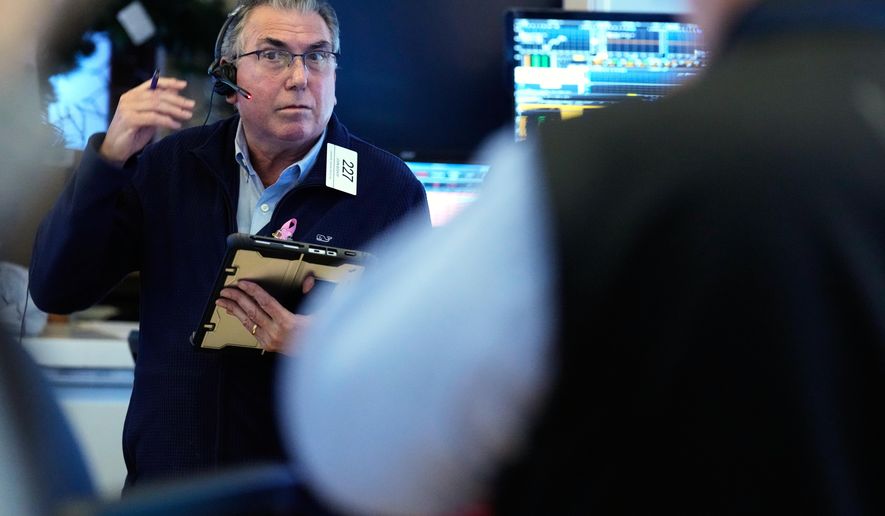 John Bishop works on the floor at the New York Stock Exchange in New York, Wednesday, Oct. 1, 2025. (AP Photo/Seth Wenig)