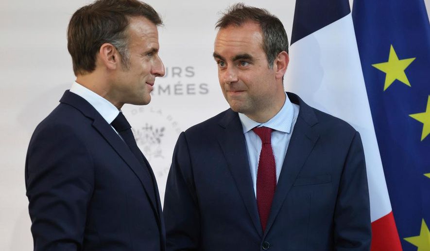 FILE - Then French Defense minister Sebastien Lecornu, right, and France's President Emmanuel Macron talk at the end of an address by the president to army leaders in Paris Sunday July 13, 2025, (Ludovic Marin, Pool via AP, File)