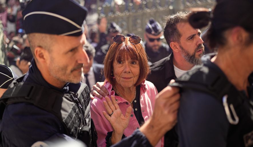 Gisele Pelicot arrives to an appeals court set to hear the case of a man challenging his conviction, less than a year after the landmark verdict in a drugging and rape trial that shook France, Monday, Oct. 6, 2025 in Nimes, southern France. (AP Photo/Lewis Joly)