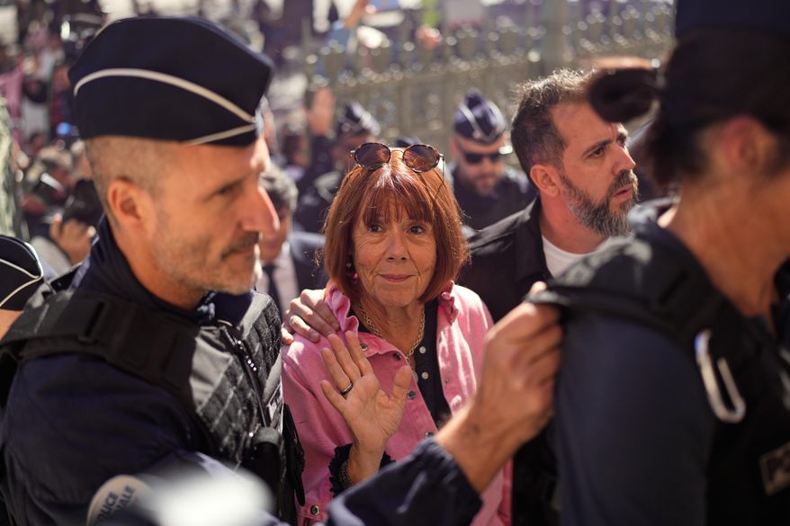 Gisele Pelicot arrives to an appeals court set to hear the case of a man challenging his conviction, less than a year after the landmark verdict in a drugging and rape trial that shook France, Monday, Oct. 6, 2025 in Nimes, southern France. (AP Photo/Lewis Joly)