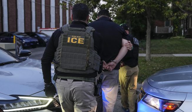 U.S. Immigration and Customs Enforcement agents make an arrest during an early morning operation in Park Ridge, Ill., Friday, Sept. 19, 2025. (AP Photo/Erin Hooley)