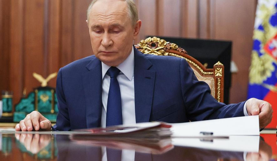 Russian President Vladimir Putin attends a meeting with Russian Deputy Prime Minister Dmitri Patrushev at the Kremlin in Moscow, Russia, Monday, Oct. 6, 2025. (Alexander Kazakov, Sputnik, Kremlin Pool Photo via AP)