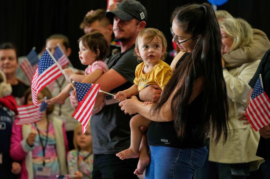 Afrikaner refugees from South Africa holding American flags arrive, May 12, 2025, at Dulles International Airport in Dulles, Va. (AP Photo/Julia Demaree Nikhinson, File)