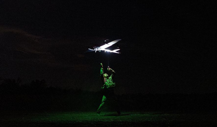 A Ukrainian serviceman with the Safari Unit of the Liut Brigade launches a reconnaissance drone at the frontline in the Donetsk region, Ukraine, on Sept. 6, 2025. (AP Photo/Vasilisa Stepanenko)