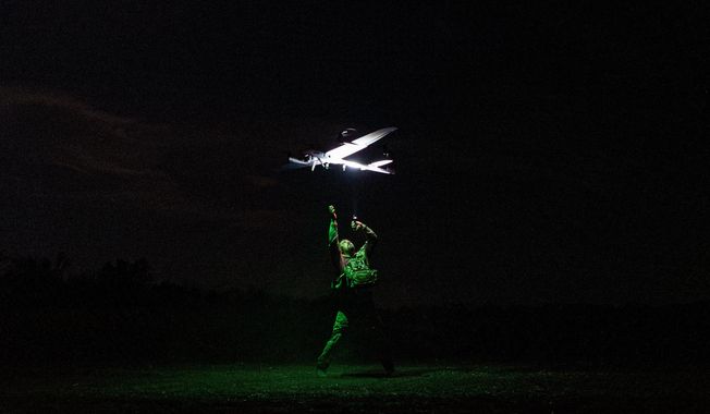 A Ukrainian serviceman with the Safari Unit of the Liut Brigade launches a reconnaissance drone at the frontline in the Donetsk region, Ukraine, on Sept. 6, 2025. (AP Photo/Vasilisa Stepanenko)