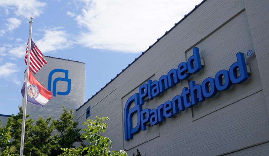 A Missouri and an American flag fly outside the Planned Parenthood in St. Louis on June 24, 2022. (AP Photo/Jeff Roberson, File)