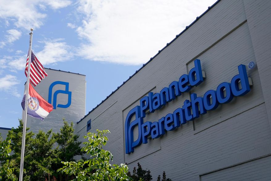 A Missouri and an American flag fly outside the Planned Parenthood in St. Louis on June 24, 2022. (AP Photo/Jeff Roberson, File)
